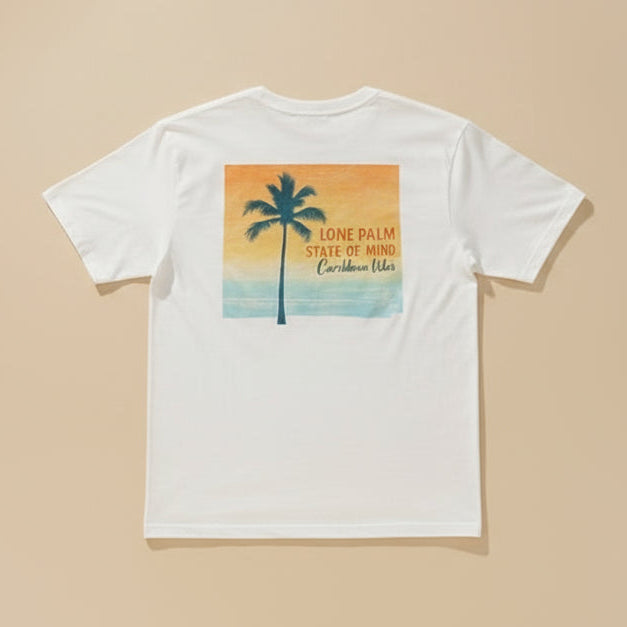 Person wearing a t-shirt with a palm tree design and text on a beach